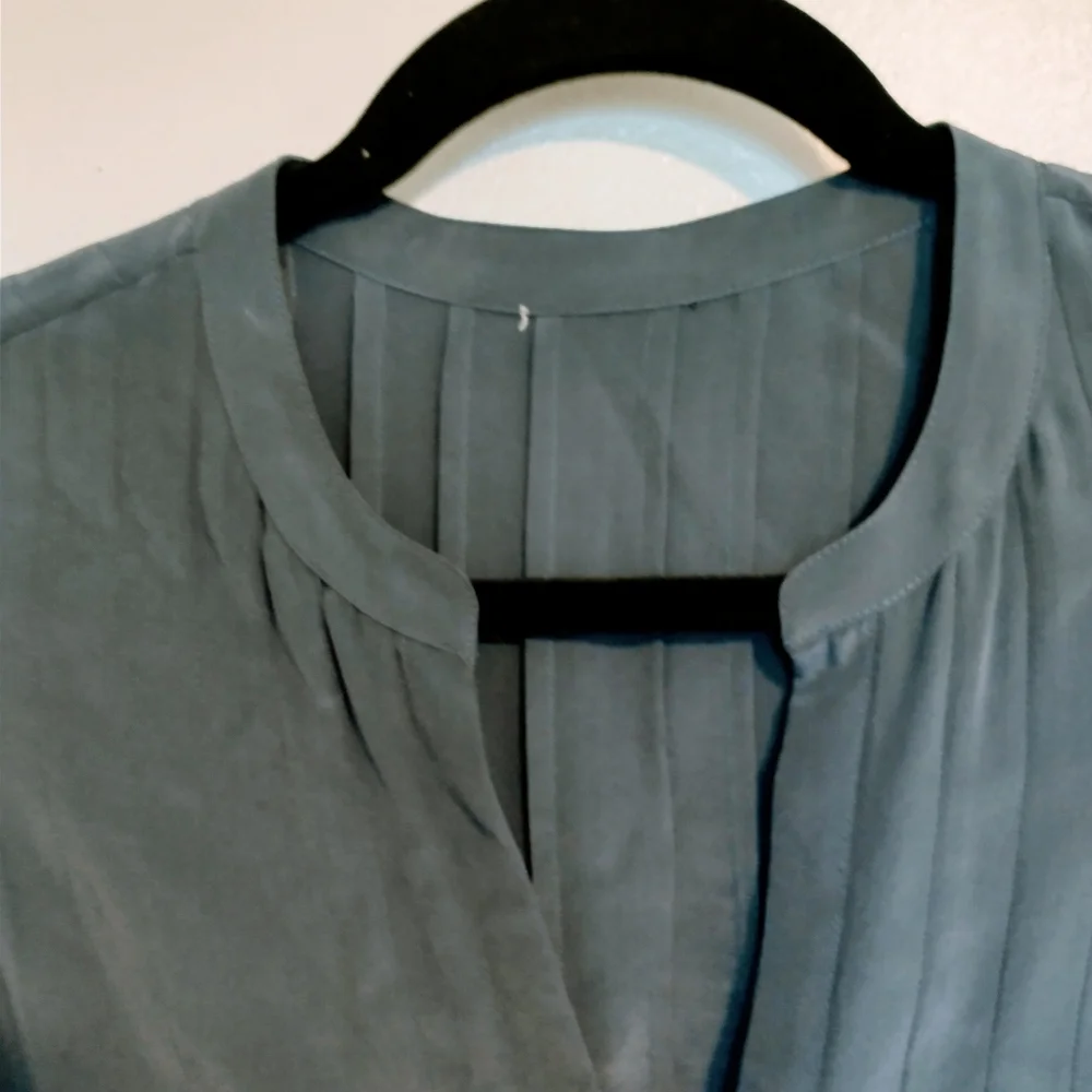 Blue top with front buttons. Tags have been removed. I believe it is jcrew size